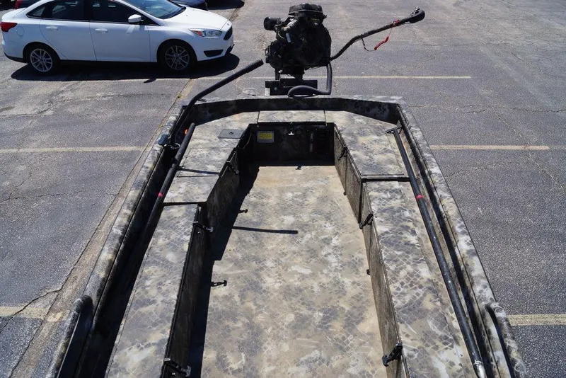 Slide: The Image of Camouflage-patterned Excel 1751 F4 boat, 2021 model, parked in a lot with a white car nearby. - 6