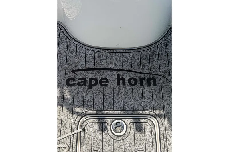Slide: The Image of 2020 Cape Horn 22 OS boat deck with logo and textured surface. - 10