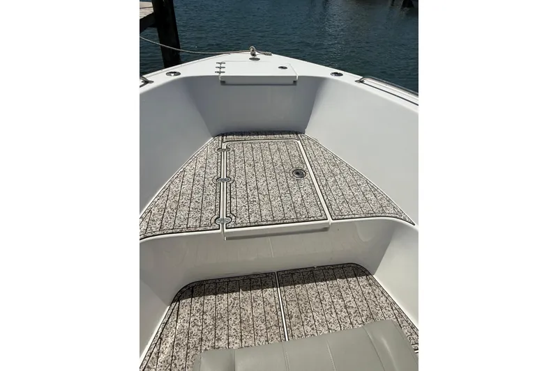 Slide: The Image of 2020 Cape Horn 22 OS boat deck with patterned flooring, docked by the water. - 3