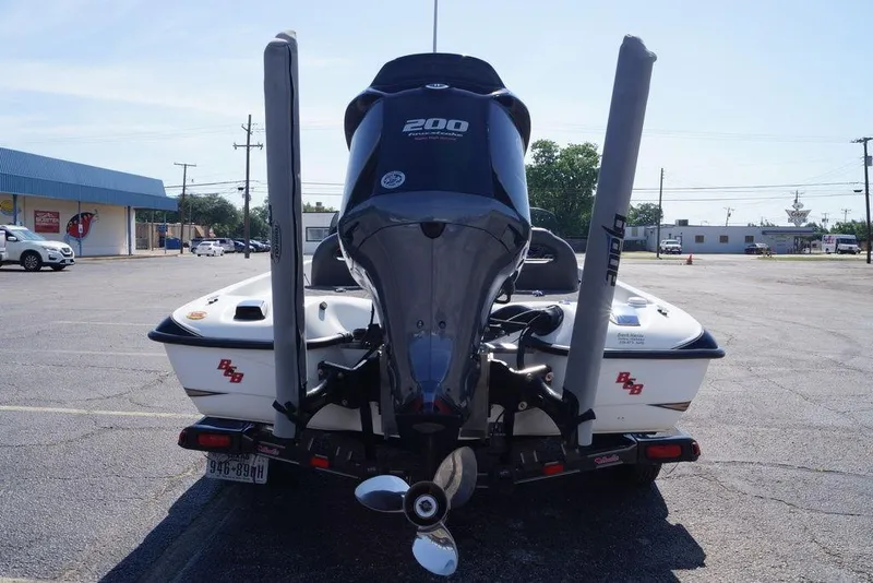 The Image of 2011 Bass Cat Pantera II boat with powerful outboard motor in a parking lot. - 1