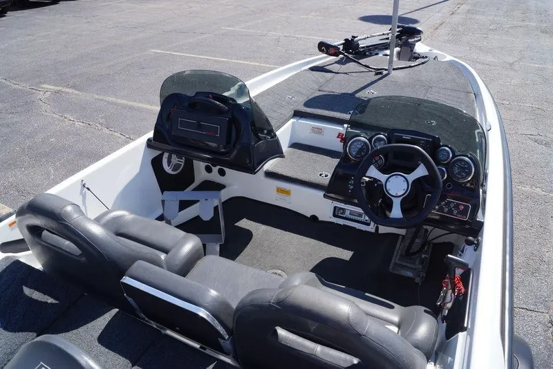 Slide: The Image of 2011 Bass Cat Pantera II boat interior with steering wheel and seating. - 11