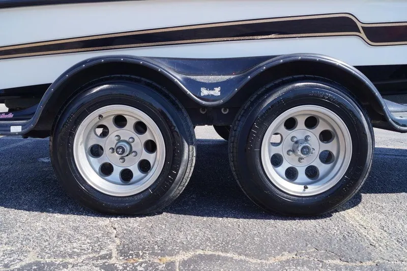 Slide: The Image of 2011 Bass Cat Pantera II trailer with dual wheels on asphalt surface. - 12
