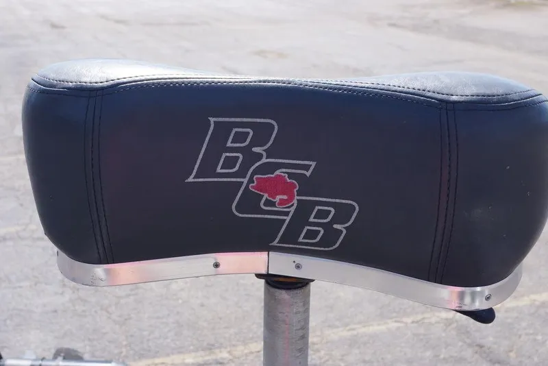 Slide: The Image of Bass Cat Pantera II 2011 boat seat with logo, featuring black leather upholstery. - 18