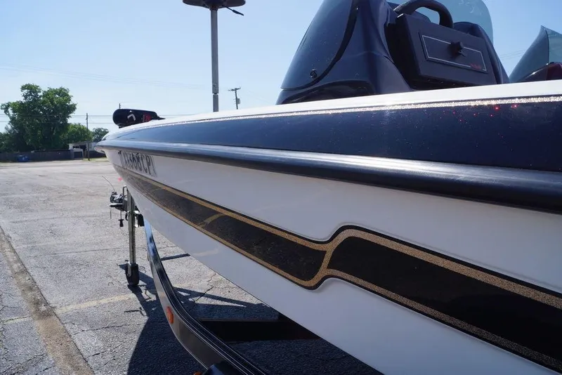 Slide: The Image of 2011 Bass Cat Pantera II boat, sleek design, parked outdoors on a sunny day. - 22