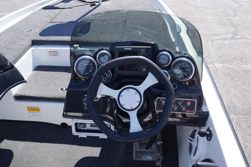 Slide: The Image of 2011 Bass Cat Pantera II boat dashboard with steering wheel and gauges. - 3