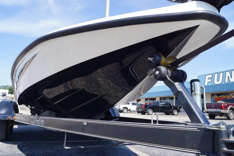 Slide: The Image of 2011 Bass Cat Pantera II boat on trailer, parked in a lot. - 4