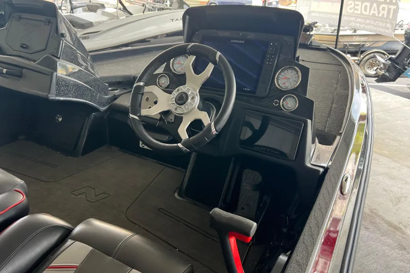 Slide: The Image of 2024 Nitro Z21 XL Pro boat cockpit with steering wheel and dashboard controls. - 5