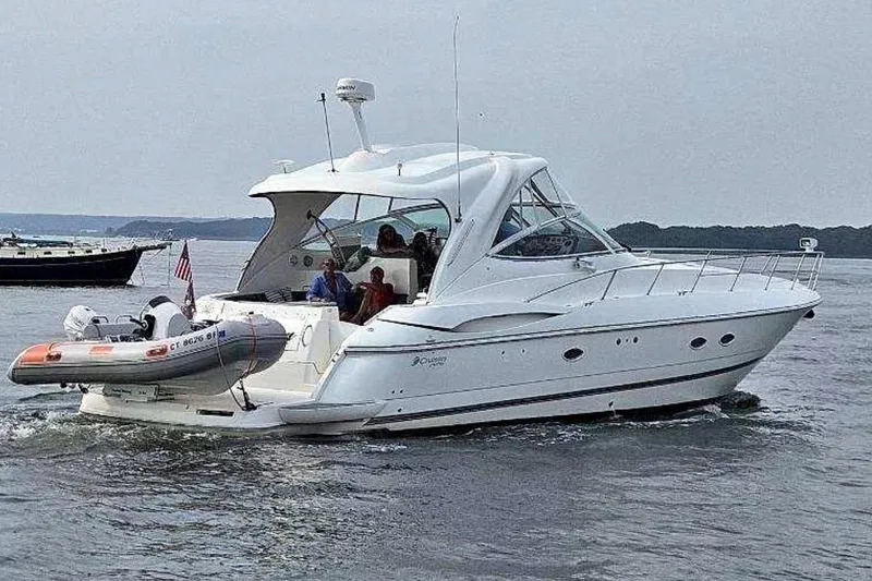 The Image of 2006 Cruisers Yachts 460 Express on water, featuring sleek design and spacious deck. - 0