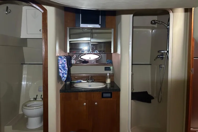 Slide: The Image of Luxurious bathroom in 2006 Cruisers Yachts 460 Express, featuring shower and vanity. - 11