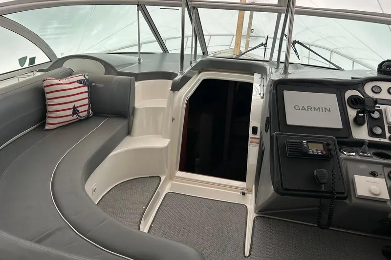 Slide: The Image of 2006 Cruisers Yachts 460 Express cockpit with Garmin navigation and plush seating. - 2