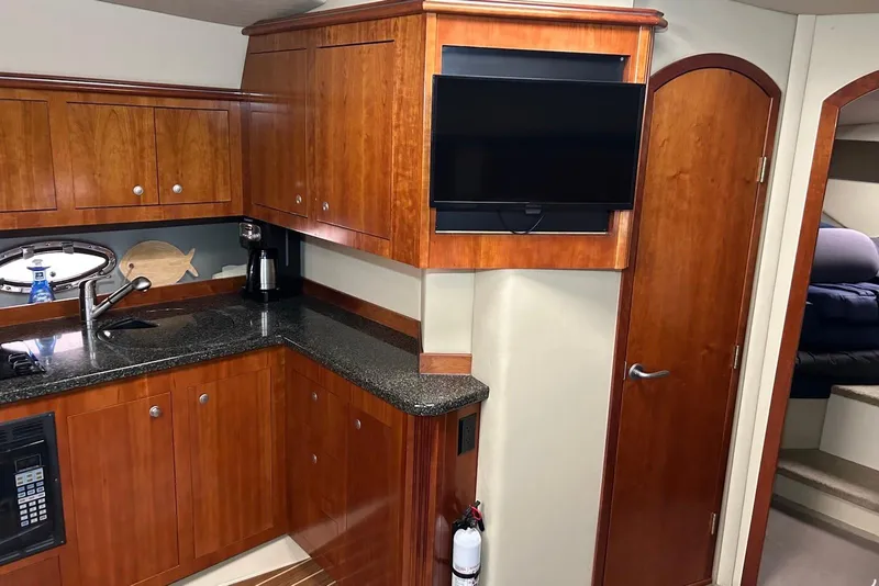 Slide: The Image of Interior of 2006 Cruisers Yachts 460 Express with wood cabinetry and modern amenities. - 6