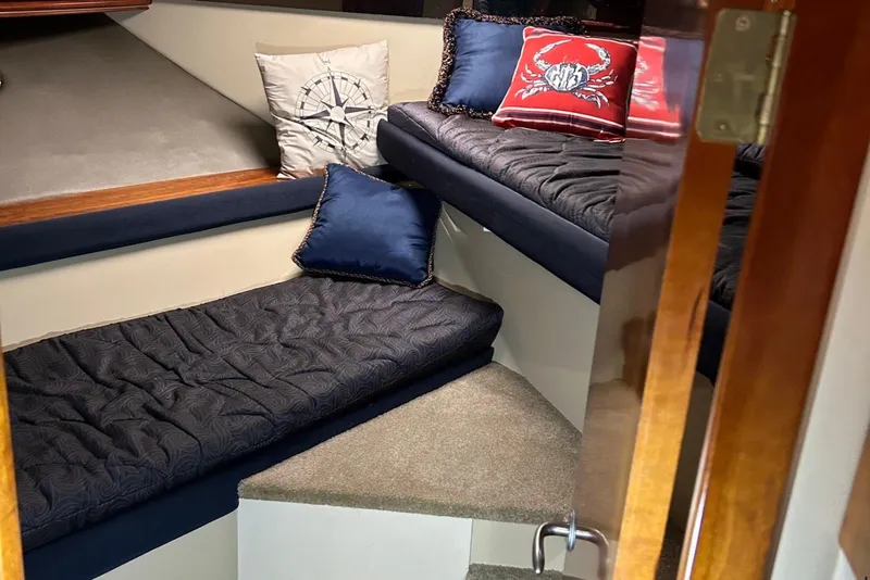 Slide: The Image of Interior cabin of 2006 Cruisers Yachts 460 Express with nautical-themed pillows. - 7