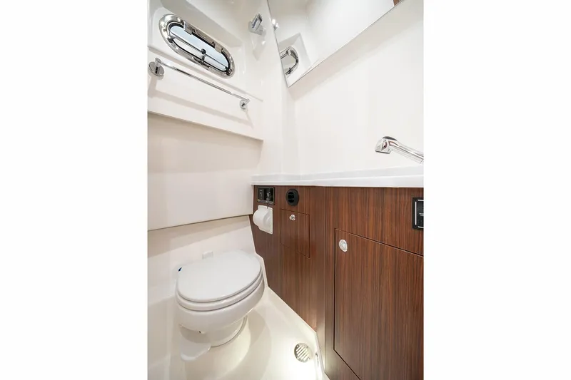 Slide: The Image of Manufacturer Provided Image: 2025 Pursuit S 358 Sport boat bathroom with modern fixtures and wood cabinetry. - 14
