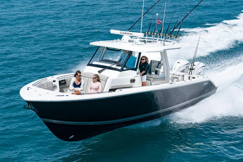 Slide: The Image of Manufacturer Provided Image: 2025 Pursuit S 358 Sport boat cruising on open water with passengers. - 2