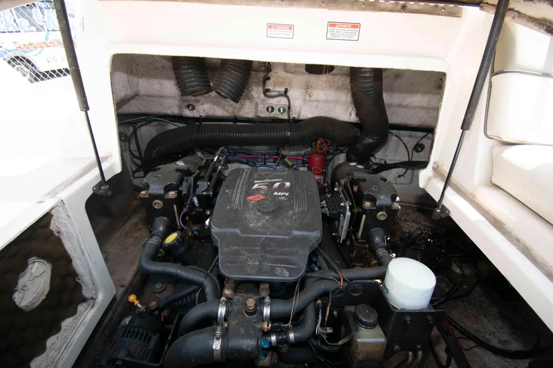 Slide: The Image of Engine compartment of a 2005 Sea Ray 240 Sundeck boat, featuring a MerCruiser engine. - 11