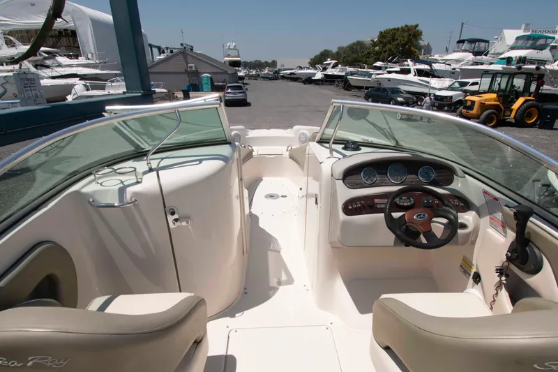 Slide: The Image of Interior view of a 2005 Sea Ray 240 Sundeck boat at a marina. - 5