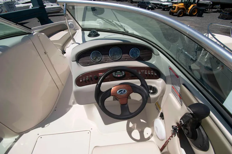 Slide: The Image of 2005 Sea Ray 240 Sundeck boat cockpit with steering wheel and instrument panel. - 6