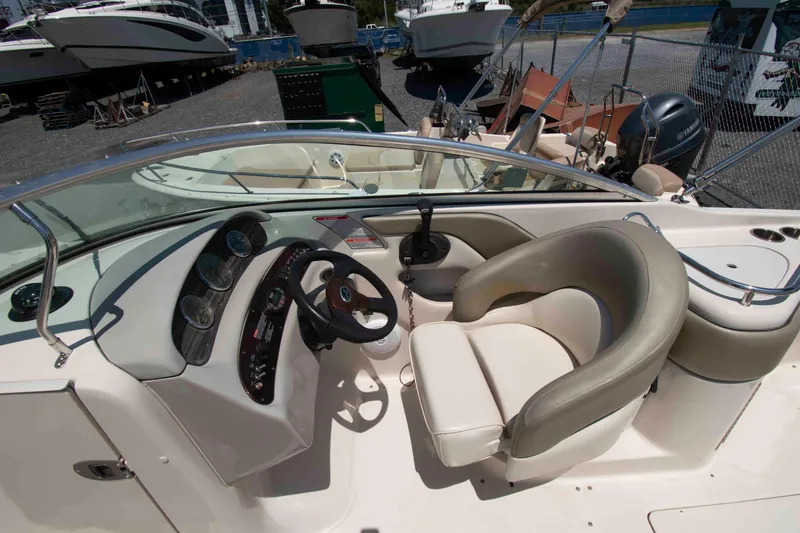 Slide: The Image of 2005 Sea Ray 240 Sundeck boat interior with steering wheel and seating area. - 8