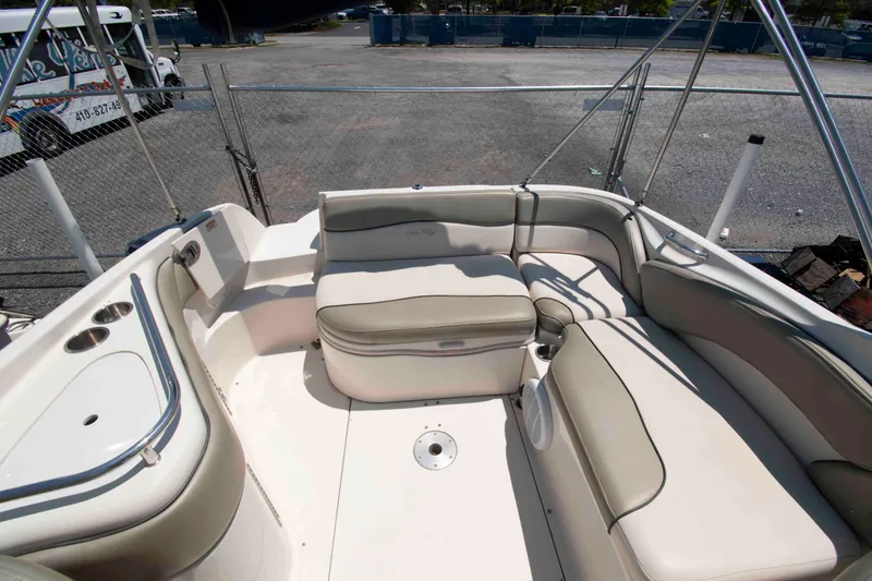 Slide: The Image of 2005 Sea Ray 240 Sundeck interior with spacious seating and cup holders. - 9