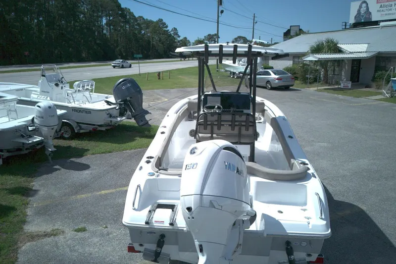 Slide: The Image of 2026 Sea Hunt Ultra 219 boat with Yamaha engine, parked outdoors near dealership. - 10
