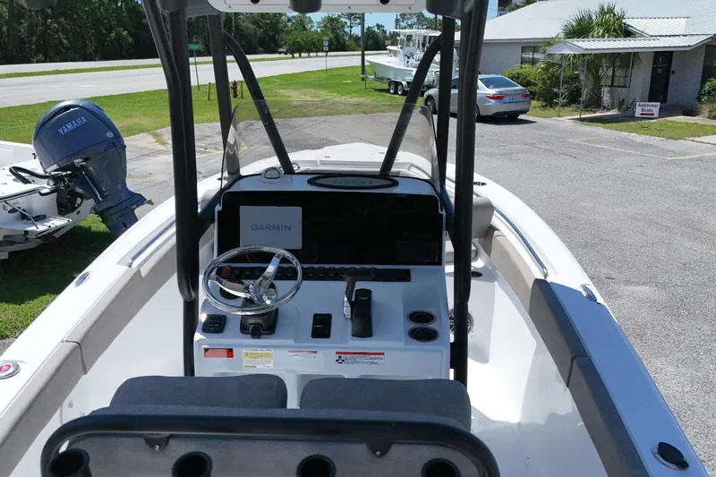 Slide: The Image of 2026 Sea Hunt Ultra 219 boat interior with Garmin navigation and Yamaha engine in a parking area. - 6