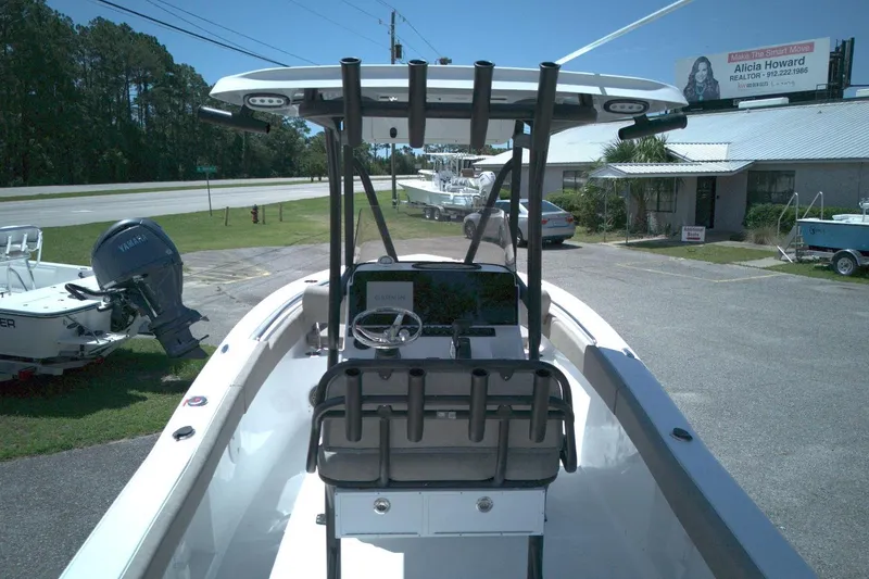 Slide: The Image of 2026 Sea Hunt Ultra 219 boat with Yamaha engine, parked outdoors near a building. - 7