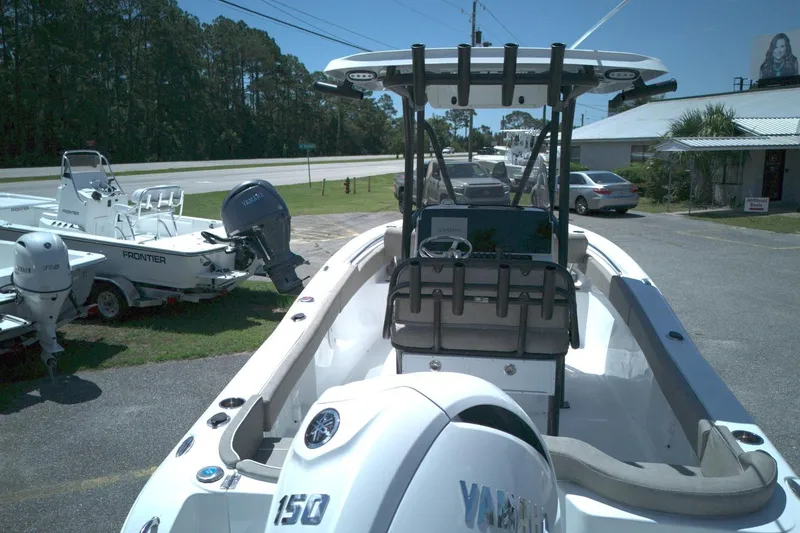 Slide: The Image of 2026 Sea Hunt Ultra 219 boat with Yamaha engine, parked outdoors near other boats. - 8
