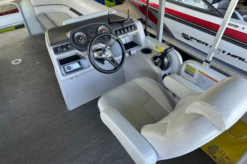 Slide: The Image of 2022 Godfrey Sweetwater 2286 SB boat interior with steering console and captain's chair. - 10