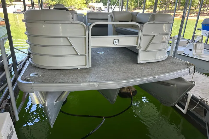Slide: The Image of 2022 Godfrey Sweetwater 2286 SB pontoon boat docked on a lake. - 2