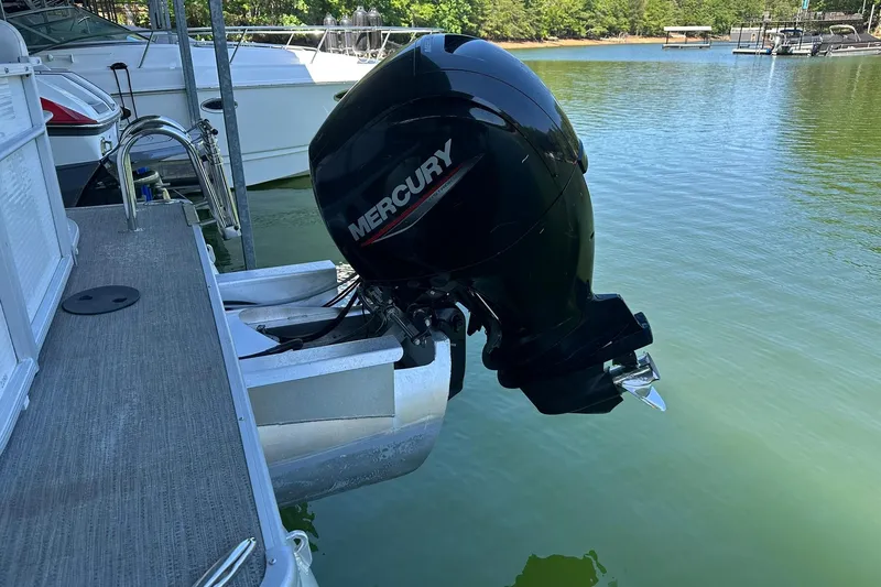 Slide: The Image of 2022 Godfrey Sweetwater 2286 SB with Mercury outboard motor on a lake. - 5