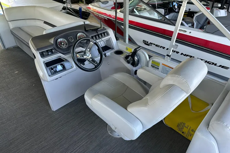 Slide: The Image of Interior of 2022 Godfrey Sweetwater 2286 SB boat with steering console and seating. - 7