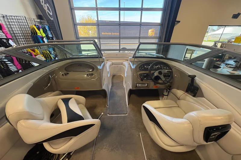 Slide: The Image of Interior view of a 2008 Crownline 210 LS boat with white seating and dashboard. - 10