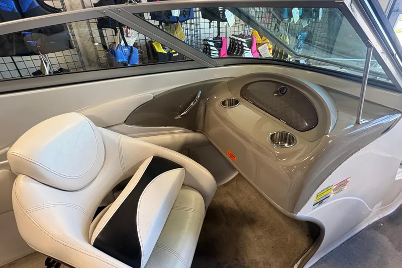 Slide: The Image of Interior of a 2008 Crownline 210 LS boat with seating and dashboard details. - 11