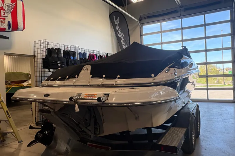 Slide: The Image of 2008 Crownline 210 LS boat on trailer in showroom, covered and ready for display. - 5