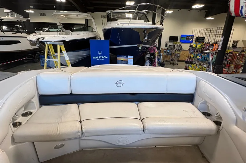Slide: The Image of Interior view of a 2008 Crownline 210 LS boat with white seating in a showroom. - 9