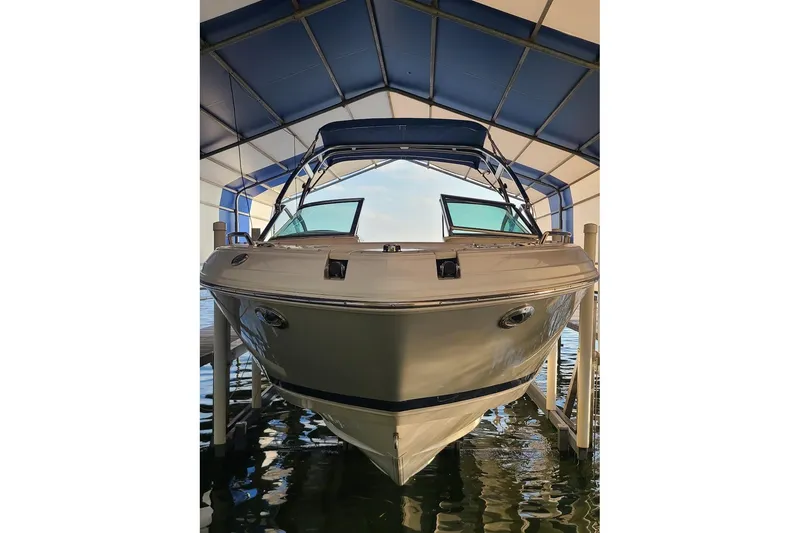Slide: The Image of 2009 Bryant 268 boat docked under a blue canopy, front view. - 10