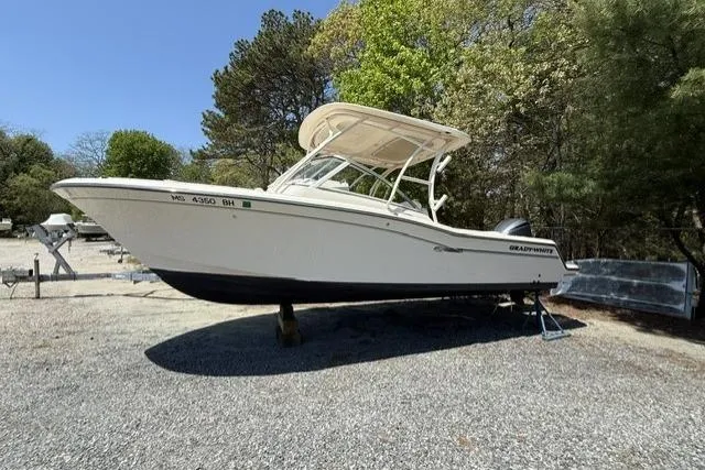 The Image of 2017 Grady-White Freedom 235 boat on gravel lot, surrounded by trees. - 1