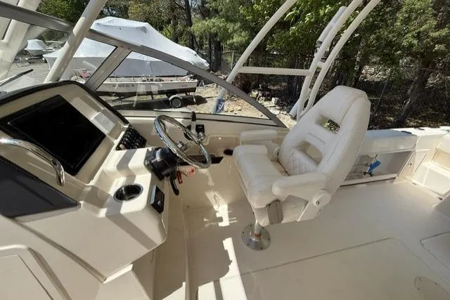Slide: The Image of 2017 Grady-White Freedom 235 boat interior with helm and captain's chair. - 13