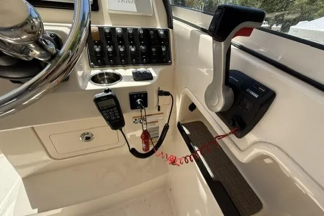 Slide: The Image of Control panel of 2017 Grady-White Freedom 235 boat with steering wheel and throttle. - 14