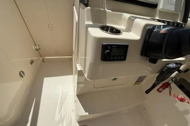 Slide: The Image of Interior view of a 2017 Grady-White Freedom 235 boat cockpit with control panel. - 17