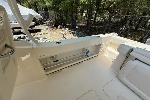 Slide: The Image of 2017 Grady-White Freedom 235 boat interior with seating and storage, outdoors. - 22