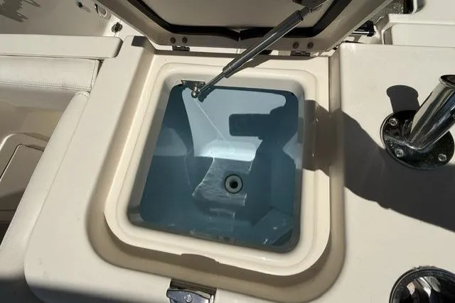Slide: The Image of Livewell compartment on a 2017 Grady-White Freedom 235 boat, open and empty. - 25