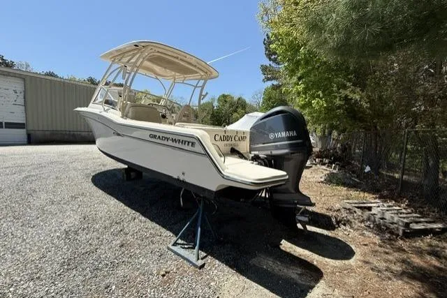 Slide: The Image of 2017 Grady-White Freedom 235 boat with Yamaha engine, parked outdoors on gravel. - 4