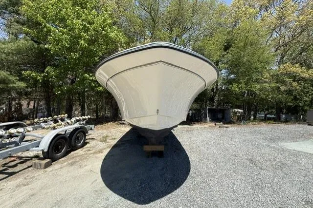 Slide: The Image of 2017 Grady-White Freedom 235 boat on trailer, parked outdoors with trees in background. - 5