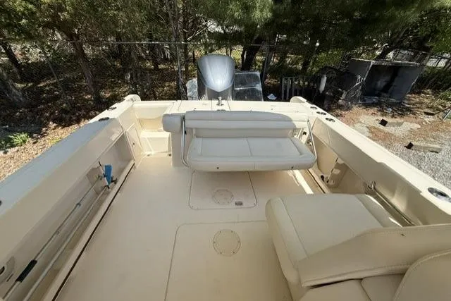 Slide: The Image of 2017 Grady-White Freedom 235 boat interior with seating and motor, outdoors. - 7
