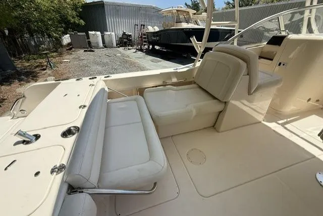 Slide: The Image of 2017 Grady-White Freedom 235 boat interior with seating and storage area. - 8