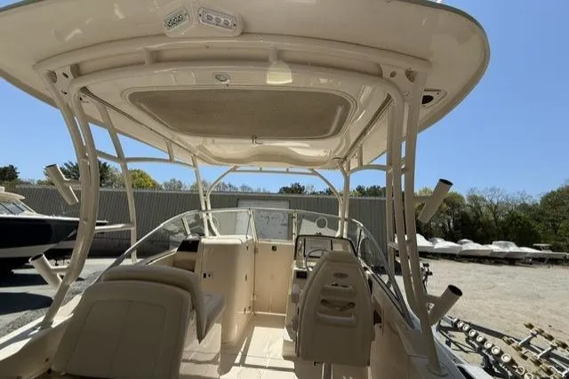 Slide: The Image of 2017 Grady-White Freedom 235 boat interior with seating and helm, parked outdoors. - 9