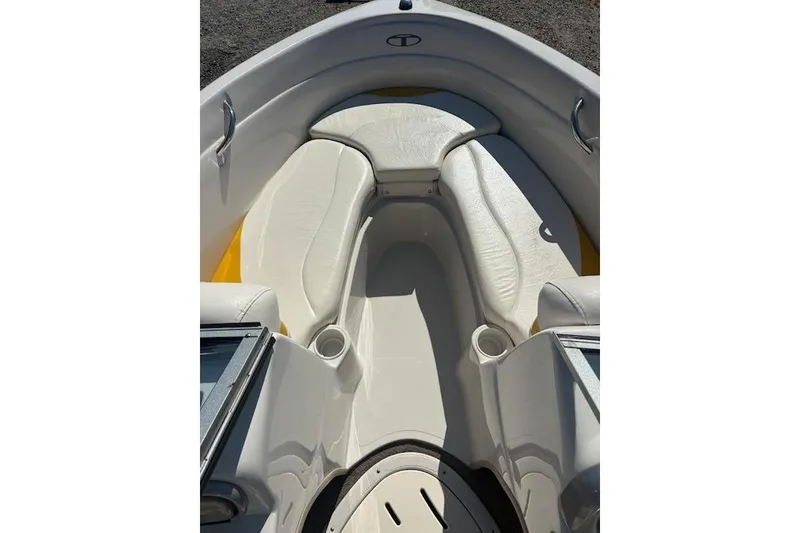 Slide: The Image of Interior view of a 2008 Tahoe Q6 Sport boat with white seating and cup holders. - 10