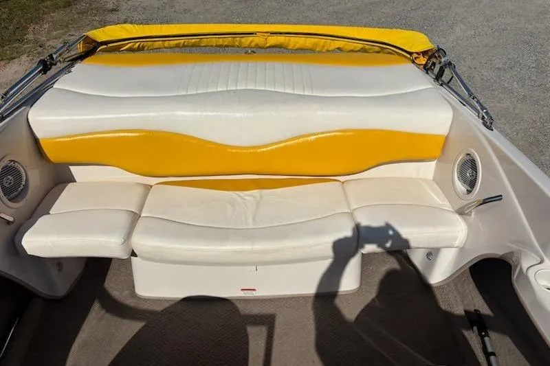 Slide: The Image of 2008 Tahoe Q6 Sport boat interior with yellow and white seating, featuring built-in speakers. - 11