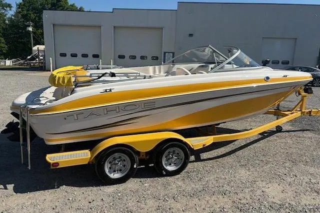 Slide: The Image of 2008 Tahoe Q6 Sport boat in yellow on a trailer, parked outdoors. - 3